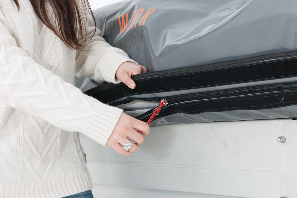 Lona de cubierta extrarresistente. La lona de cubierta está fabricada con un material de PVC especialmente grueso y resistente. Gracias a la cremallera SBS Heavy Duty y al cierre de velcro protector superior, se garantiza la máxima estanqueidad contra la lluvia y el polvo.